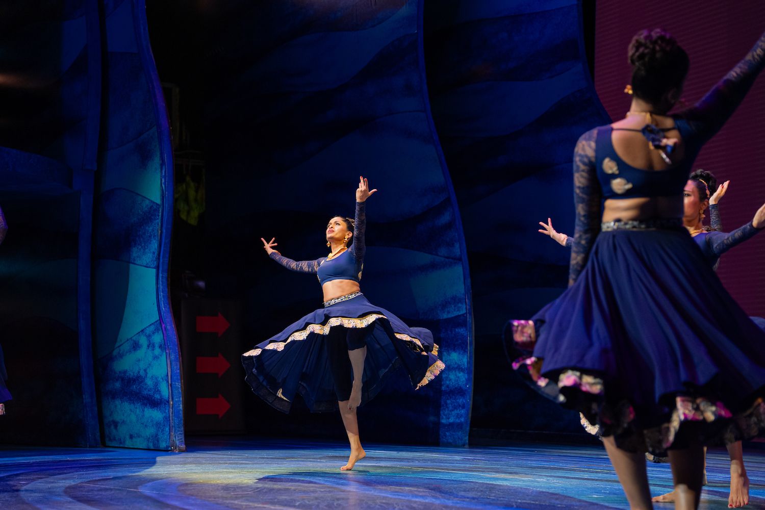 A featured dancer twirling on the showcase stage
