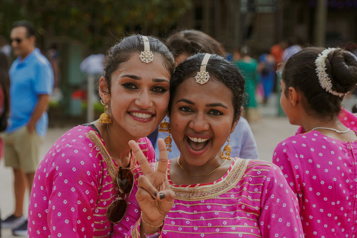 Two young dancers laughing together at the parade