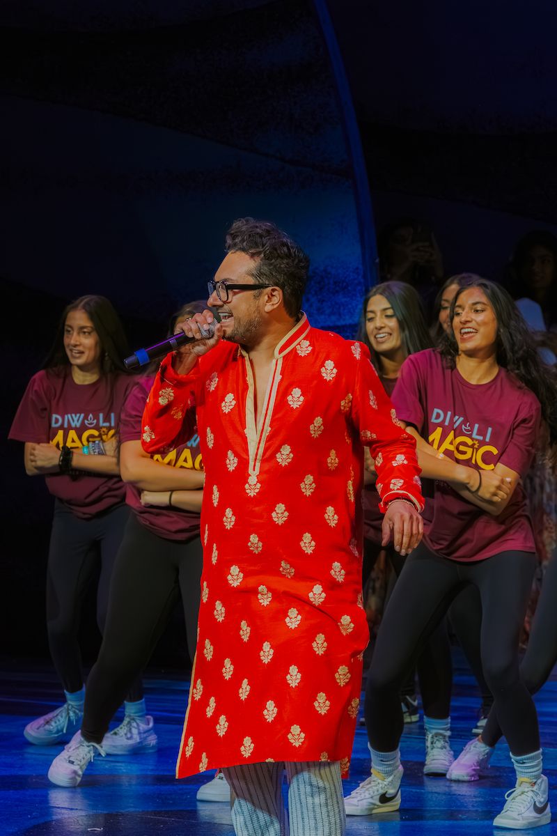 A performer in red on the showcase stage