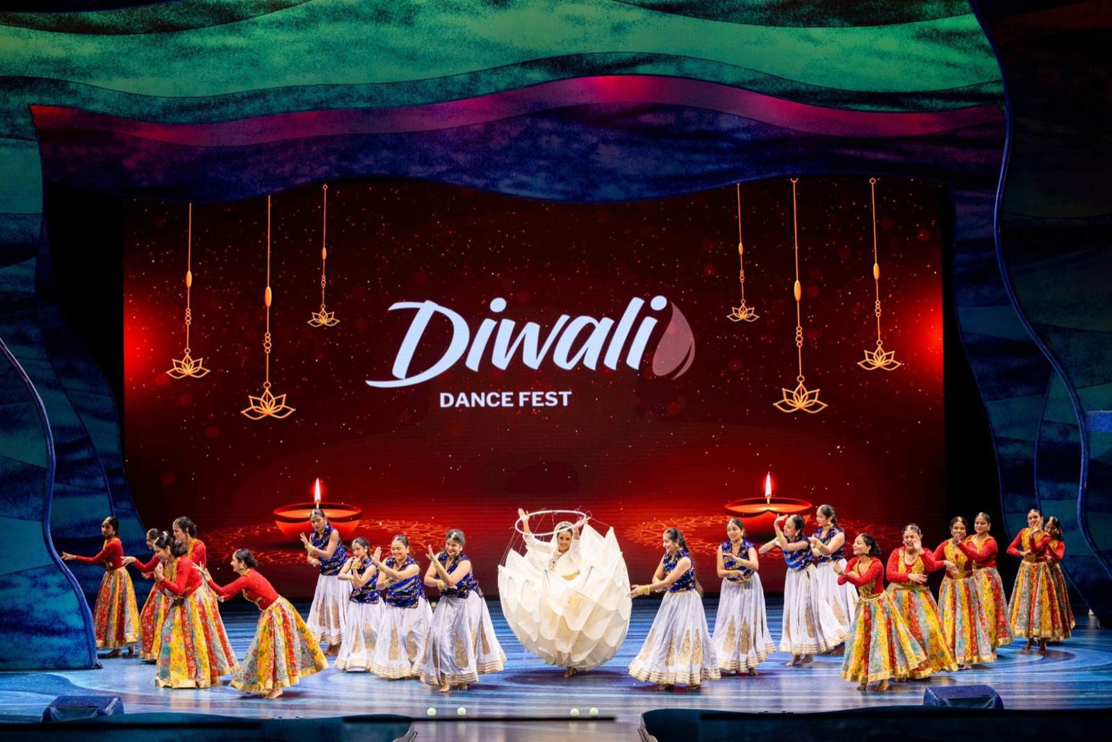 A studio performing a lotus dance on the Diwali Dance Fest stage