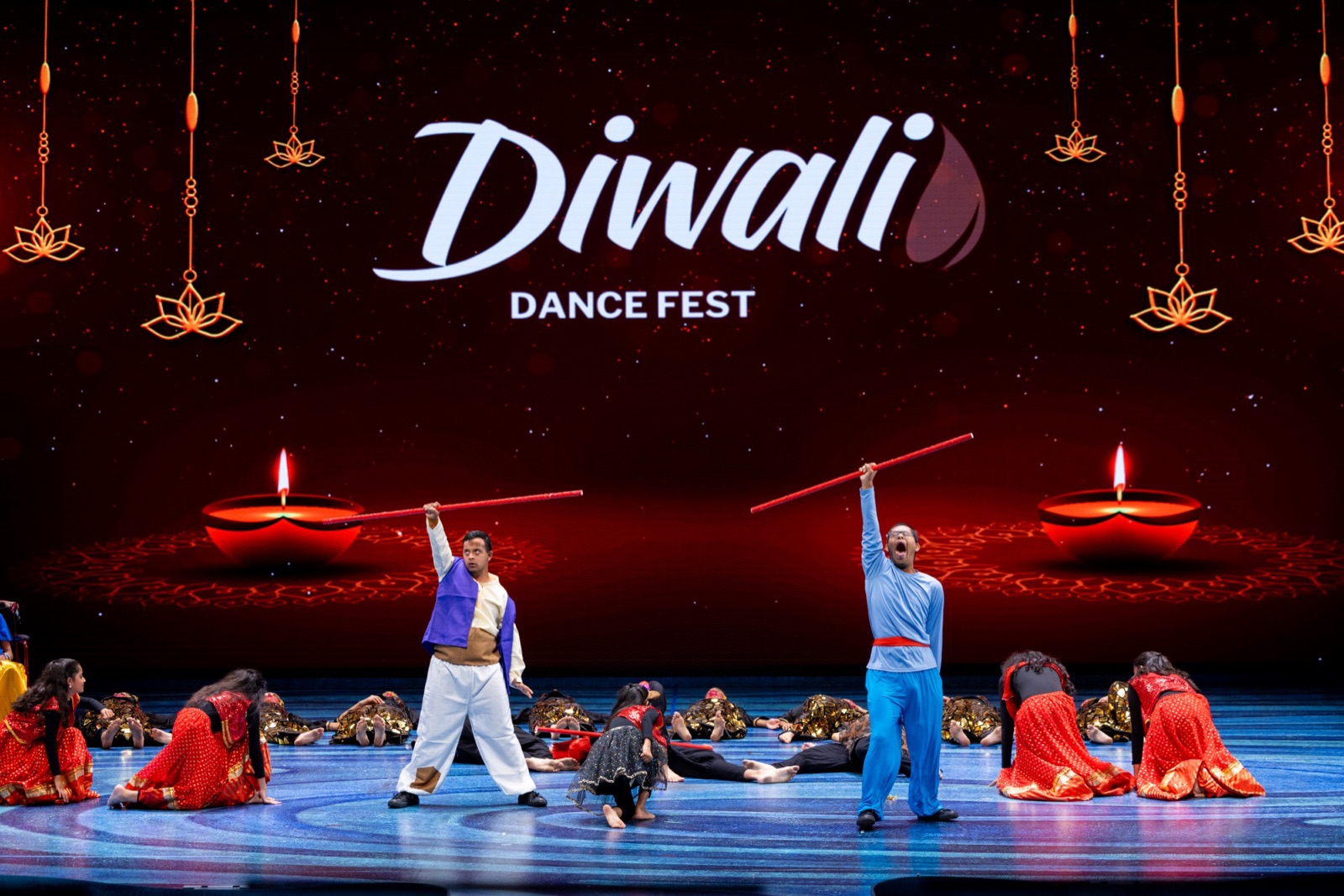 Dancers performing with sticks on the showcase stage